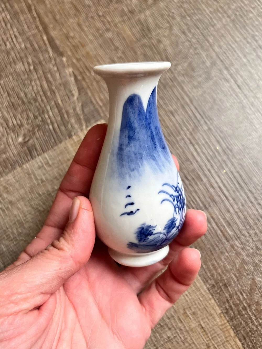 Chinese style porcelain bud vase with a flared rim and hand-painted landscape